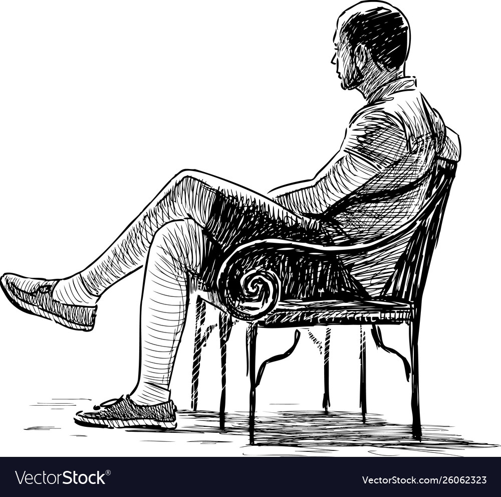 Человек сидит на стуле боком